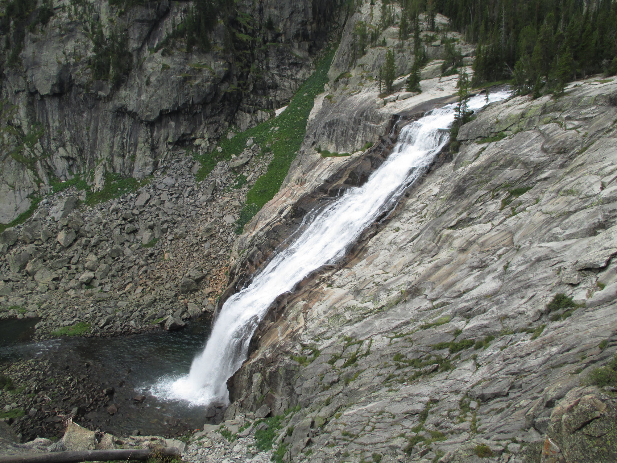 Impasse Falls cascading dramatically down open granite slickrock in the East Rosebud drainage