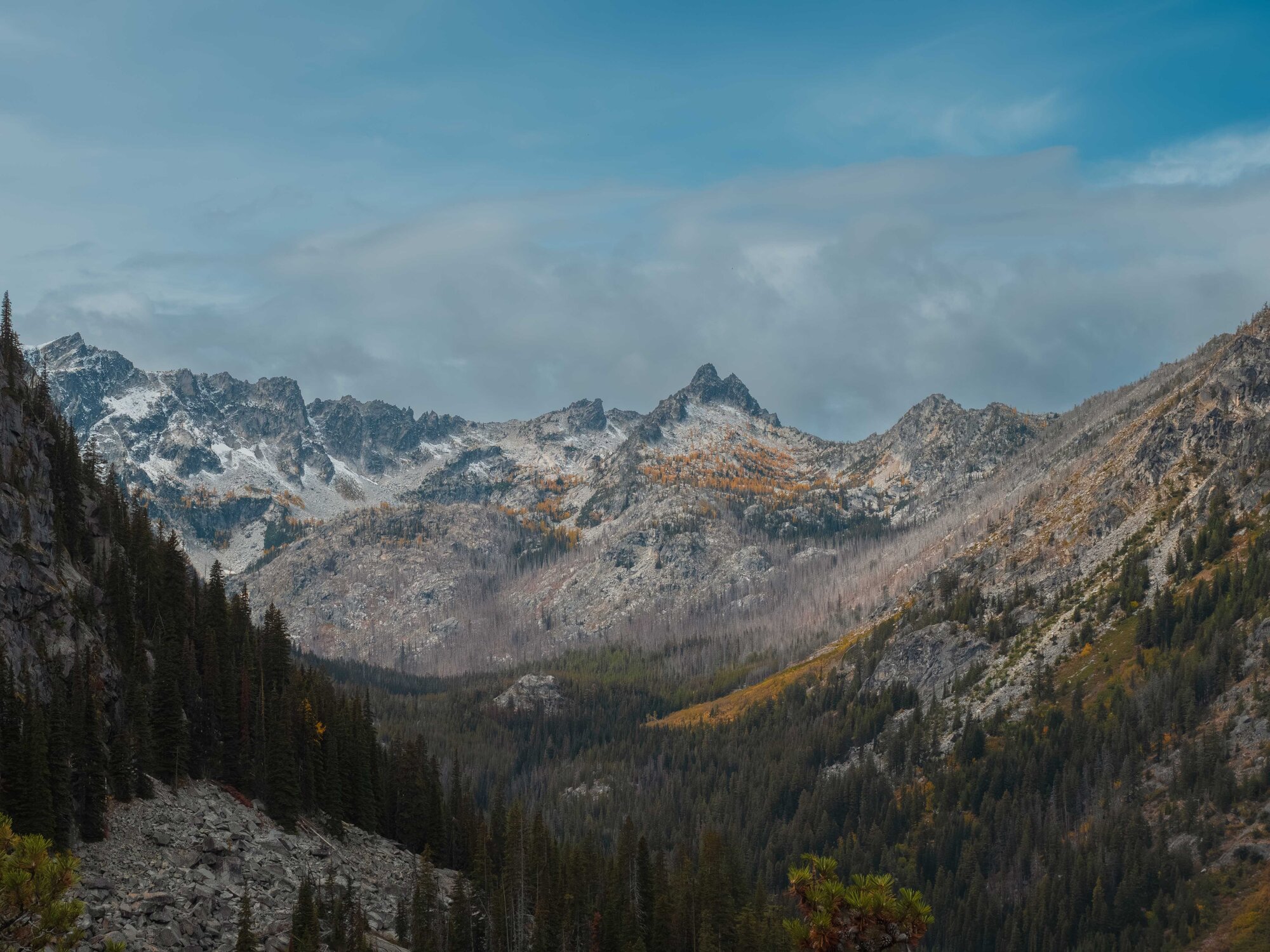 Colchuck Lake with golden larches and Dragontail Peak reflected in the water