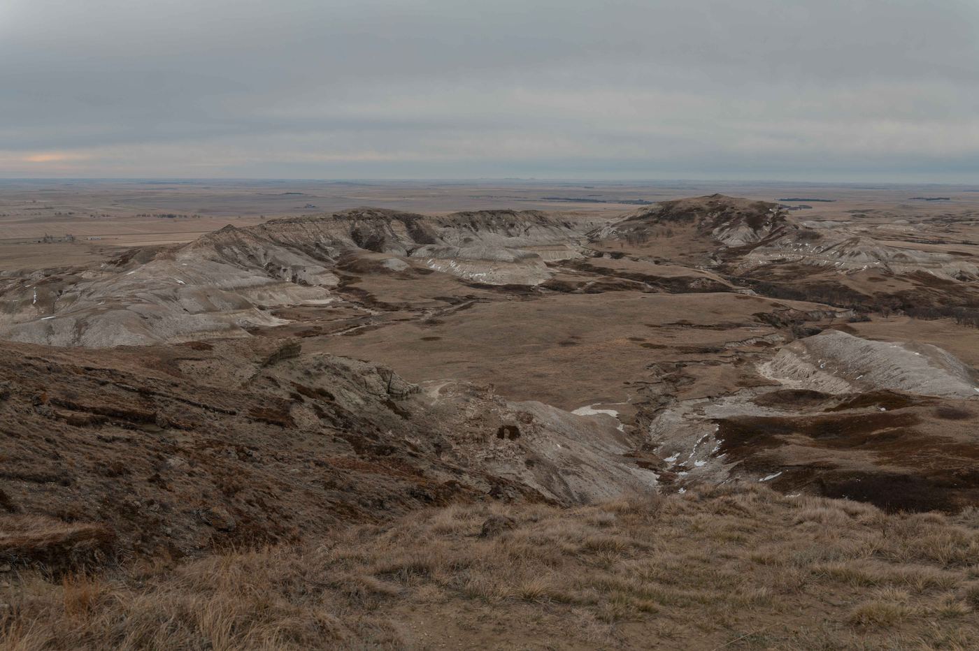 The view from near the summit of White Butte, North Dakota's highest point, showing pale badlands and open prairie rolling to the horizon